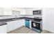 Modern kitchen features white cabinets, stainless steel appliances, and neutral counter tops at 8230 E 12Th St, Indianapolis, IN 46219
