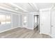 Well-lit living room featuring light hardwood floors and freshly painted walls at 8230 E 12Th St, Indianapolis, IN 46219