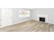 Bright living room with fireplace, fresh paint, modern floors, and lots of natural light at 8230 E 12Th St, Indianapolis, IN 46219
