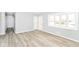 Inviting living room features new modern flooring, neutral paint, and bright windows at 8230 E 12Th St, Indianapolis, IN 46219