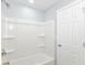 The bathroom features a clean shower-tub with shelving at 8230 E 12Th St, Indianapolis, IN 46219
