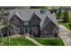 Aerial view of brick home with landscaped yard, driveway, and view of the lake at 895 Baywood Ct, Columbus, IN 47201
