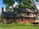 Beautiful backyard with spacious deck, brick chimney, and mature trees at 895 Baywood Ct, Columbus, IN 47201