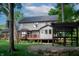 Expansive backyard featuring a spacious deck, stone firepit, and lush greenery at 895 Baywood Ct, Columbus, IN 47201