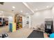 Unfinished basement area with storage shelves and workout equipment near a finished room at 895 Baywood Ct, Columbus, IN 47201
