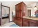 Elegant bathroom with dark wood cabinetry, granite countertops, and a doorway to the main bedroom at 895 Baywood Ct, Columbus, IN 47201