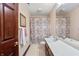 Traditional bathroom with vanity, floral shower curtain, and a mirrored wall for added light at 895 Baywood Ct, Columbus, IN 47201
