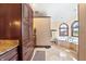 Luxurious bathroom features a jetted tub, custom cabinetry, and granite counters at 895 Baywood Ct, Columbus, IN 47201