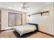 Cozy bedroom featuring a platform bed, window with blinds, and a wooden shelf on the wall at 895 Baywood Ct, Columbus, IN 47201