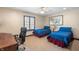 Bright bedroom featuring two twin beds, ceiling fan, and natural light from the window at 895 Baywood Ct, Columbus, IN 47201