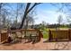 Outdoor deck with chairs overlooking a serene pond and neighboring houses in a picturesque setting at 895 Baywood Ct, Columbus, IN 47201