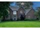Charming two-story brick home featuring a well-manicured lawn and mature trees at 895 Baywood Ct, Columbus, IN 47201