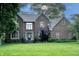 Charming two-story brick home with a well-manicured lawn and mature trees, showcasing classic architectural details at 895 Baywood Ct, Columbus, IN 47201