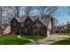 Elegant brick home with a well-manicured lawn, mature trees and an expansive driveway at 895 Baywood Ct, Columbus, IN 47201