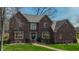 Beautiful brick home with well-maintained landscaping, a welcoming entrance, and mature trees at 895 Baywood Ct, Columbus, IN 47201