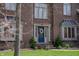 Close up of brick home showcasing a blue front door with decorative wreath and beautiful landscaping at 895 Baywood Ct, Columbus, IN 47201