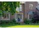 Beautiful entryway with a blue door, decorative wreath, and lush landscaping at 895 Baywood Ct, Columbus, IN 47201