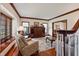 Bright living room with hardwood floors, a bay window, and an adjacent staircase at 895 Baywood Ct, Columbus, IN 47201