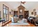 Inviting living room with a brick fireplace, built-in bookshelves, and large windows at 895 Baywood Ct, Columbus, IN 47201