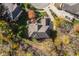 Aerial view of the house, showcasing roofline, landscaping, and cul-de-sac location surrounded by colorful autumn trees at 9643 N Box Elder Ct, McCordsville, IN 46055