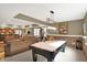 Spacious finished basement with a billiards table, exercise equipment, and comfortable seating area for relaxation at 9643 N Box Elder Ct, McCordsville, IN 46055
