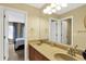 Bathroom with double sink vanity, large mirror, and doorway to bedroom at 9643 N Box Elder Ct, McCordsville, IN 46055