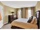 Well-lit bedroom featuring a large bed, dresser, and windows with striped curtains at 9643 N Box Elder Ct, McCordsville, IN 46055