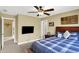 Bedroom boasts a TV, wood bed frame, ceiling fan and window providing natural light at 9643 N Box Elder Ct, McCordsville, IN 46055