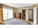 Comfortable bedroom featuring wood dresser, window with curtains and access to an ensuite bathroom at 9643 N Box Elder Ct, McCordsville, IN 46055