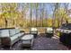 Cozy outdoor deck featuring comfortable wicker furniture, a glass table, and a modern grill at 9643 N Box Elder Ct, McCordsville, IN 46055