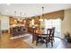 Inviting dining area with wood table set, view into the kitchen, and sliding door access to the yard at 9643 N Box Elder Ct, McCordsville, IN 46055
