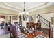 Formal dining room with hardwood floors, wainscoting and elegant chandelier at 9643 N Box Elder Ct, McCordsville, IN 46055