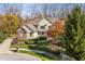 Charming two-story home with a well-manicured lawn, beautiful trees and manicured shrubs at 9643 N Box Elder Ct, McCordsville, IN 46055