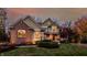 Charming two-story home with brick and stone accents, a manicured lawn, and professional landscaping at 9643 N Box Elder Ct, McCordsville, IN 46055