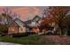 Exterior twilight photo showcasing the home's facade and a colorful tree in the front yard at 9643 N Box Elder Ct, McCordsville, IN 46055