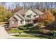 Charming two-story home featuring a well-manicured lawn, brick, and stone accents and inviting front porch at 9643 N Box Elder Ct, McCordsville, IN 46055