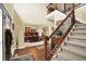Grand two-story foyer with staircase and railing, leading into the dining room at 9643 N Box Elder Ct, McCordsville, IN 46055