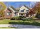 Beautiful two-story home with brick and stone accents, a manicured lawn, and mature trees at 9643 N Box Elder Ct, McCordsville, IN 46055