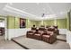 Home theater with tiered seating featuring leather reclining chairs, projector, and recessed lighting at 9643 N Box Elder Ct, McCordsville, IN 46055