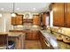 Well-appointed kitchen with granite counters, custom cabinets, and gas cooktop at 9643 N Box Elder Ct, McCordsville, IN 46055
