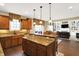 Open-concept kitchen featuring a large island and connection to the dining room and living room at 9643 N Box Elder Ct, McCordsville, IN 46055