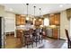 Beautiful kitchen with brown cabinets, granite countertops, stainless steel appliances, and bar stool seating at 9643 N Box Elder Ct, McCordsville, IN 46055