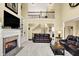 Bright, inviting living room with a fireplace and a view of the upper floor loft space at 9643 N Box Elder Ct, McCordsville, IN 46055