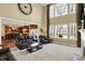 Bright living room with soaring ceilings, large windows, fireplace, and opening to the kitchen at 9643 N Box Elder Ct, McCordsville, IN 46055