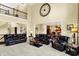Spacious living room with high ceilings, comfortable seating, and open access to the kitchen and dining area at 9643 N Box Elder Ct, McCordsville, IN 46055