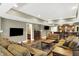 Inviting living room with hardwood floors, a flat screen TV, and a brick-accented bar area at 9643 N Box Elder Ct, McCordsville, IN 46055