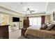 Main bedroom with ceiling fan, TV and view of the ensuite bathroom at 9643 N Box Elder Ct, McCordsville, IN 46055