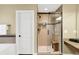 Modern shower with glass doors and tile walls, plus a wooden bench inside the shower at 9643 N Box Elder Ct, McCordsville, IN 46055