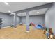 Finished basement with laminate flooring and gray walls, perfect for a playroom at 10441 Alexia Dr, Indianapolis, IN 46236