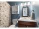 Bathroom with a cabinet above the toilet and a floral shower curtain at 10441 Alexia Dr, Indianapolis, IN 46236